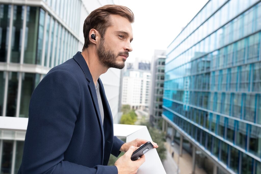 business man in suit looking over office building